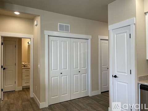 A room with white doors and a tiled floor.