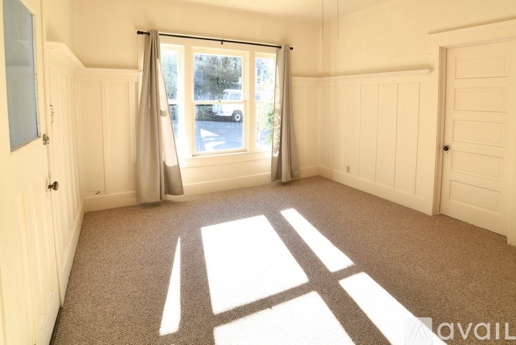 A sunny room with a car parked outside the window.