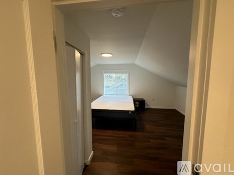 A bedroom with a bed and a window.