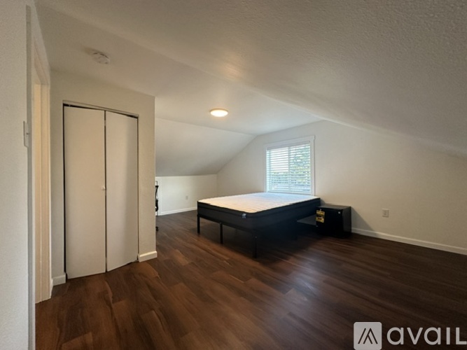 A bedroom with a bed, dresser, and wardrobe.