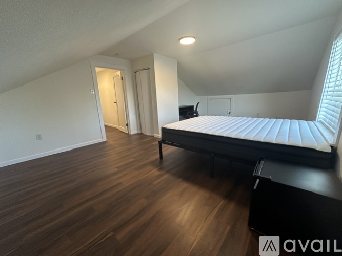 A bedroom with a bed, dresser, and mirror.