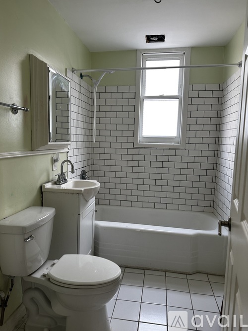 A bathroom with a toilet, sink, and bathtub.