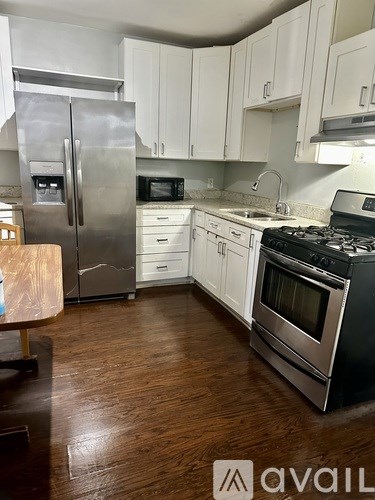 A kitchen with a stove, refrigerator, and microwave.