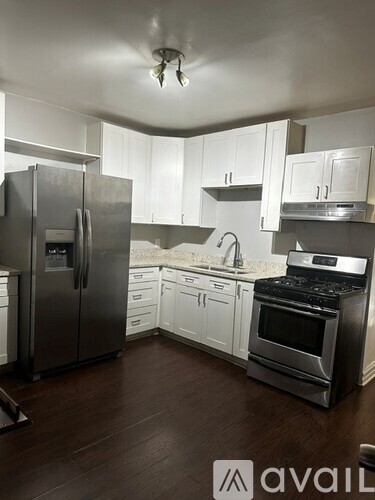 A kitchen with white cabinets and stainless steel appliances.