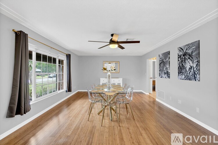 A dining room with a wooden table and chairs.