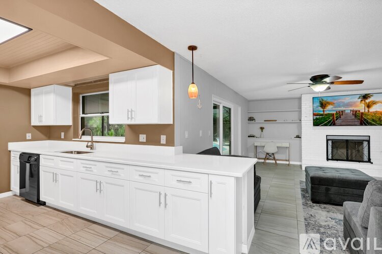 A modern kitchen with white cabinets and a large island.
