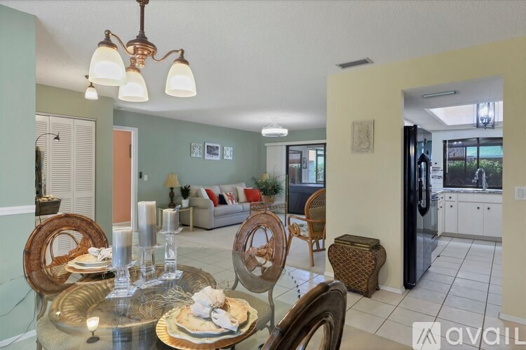 A dining room with a glass table and chairs.