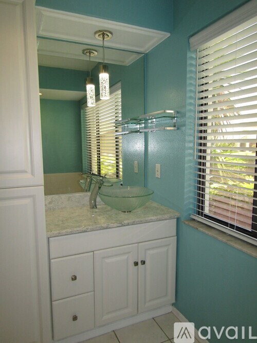 A bathroom with a blue wall and a white sink.