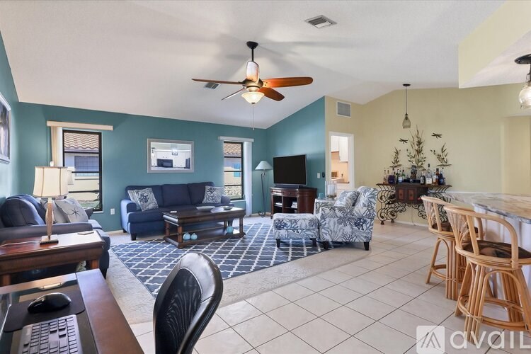 A living room with a blue couch and a television.