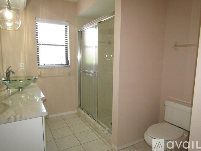 A bathroom with a sink, toilet, and shower.