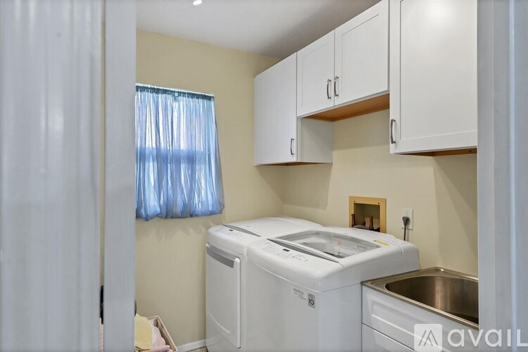 A small laundry room with a washer and dryer.