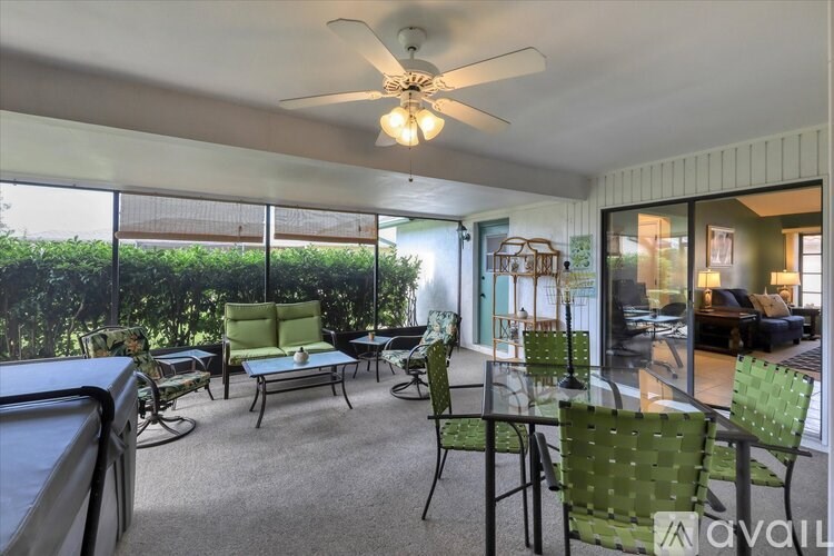 A sunroom with a table and chairs.