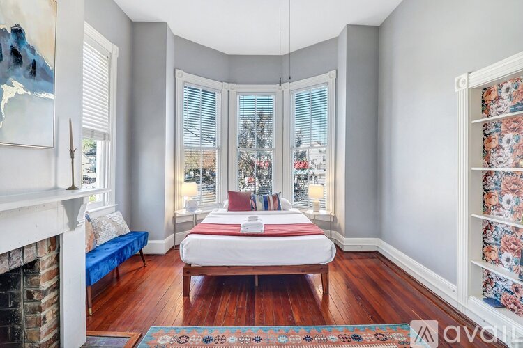 A bedroom with a bed in the middle of the room.