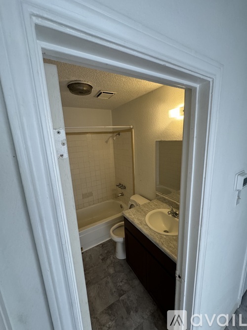 A bathroom with a toilet, sink, and bathtub.