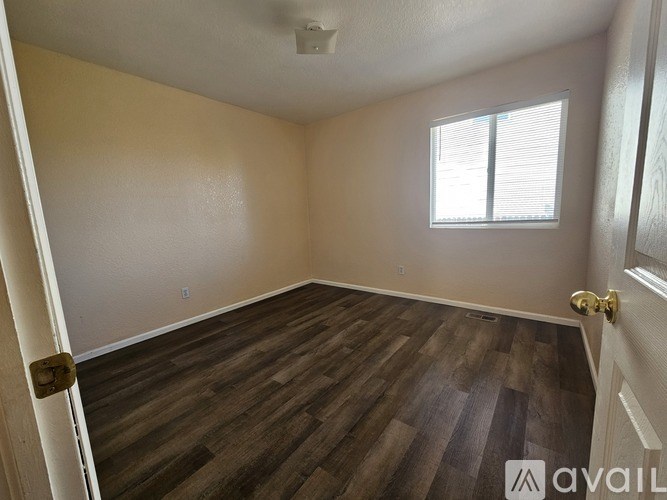 A man is walking through a doorway into a room with a white door.