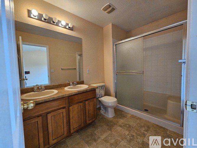 A bathroom with a toilet, sink, and shower.