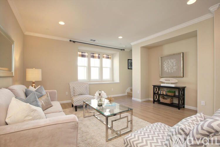 A living room with a couch, chair, and coffee table.