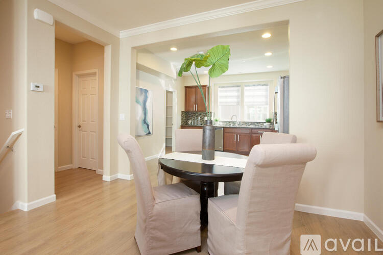 A dining room with a table and chairs.