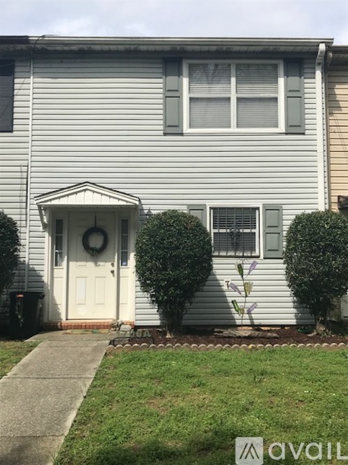 A house with a white door and a wreath on it.