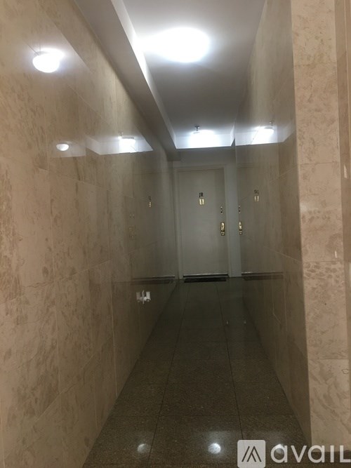 A long hallway with a door at the end.