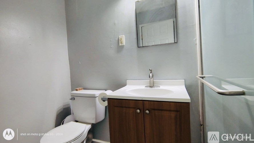 A white toilet sits next to a sink in a small bathroom.
