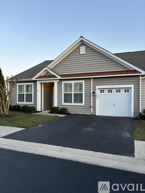 A house with a brown roof and a white garage door.