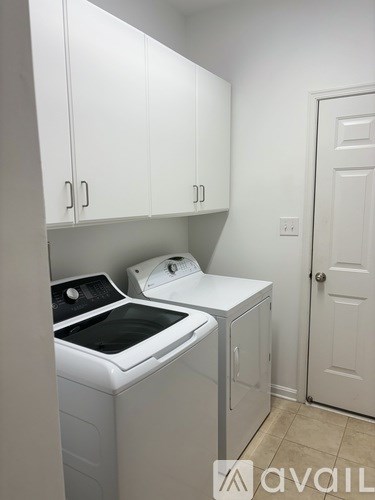 A small laundry room with a washer and dryer.