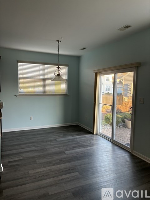 A room with a window and sliding glass doors.