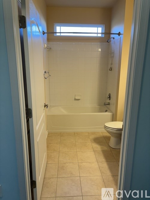 A bathroom with a toilet, tub, and shower.