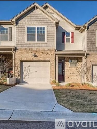 A house with a red door and a garage door is shown.