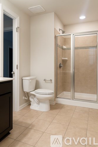 A bathroom with a toilet, sink, and a mirror.