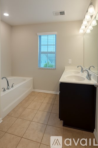 Two white front loading washing machines in a laundry room.