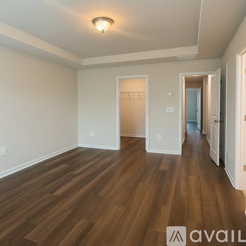 A room with wooden floors and white walls.