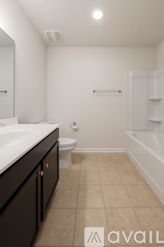 A bathroom with a toilet, sink, and a mirror.