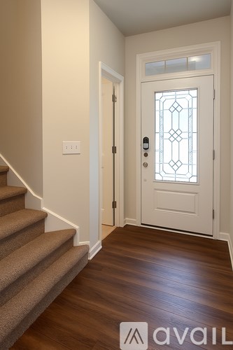A white door with a glass window is at the end of a staircase.