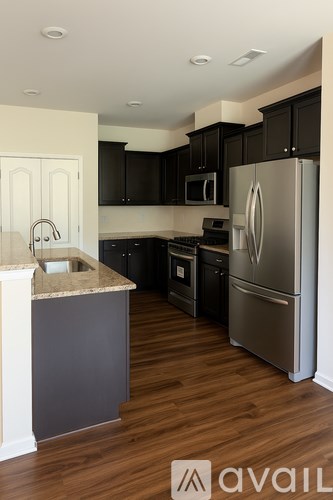A white toilet sits next to a white sink in a bathroom.