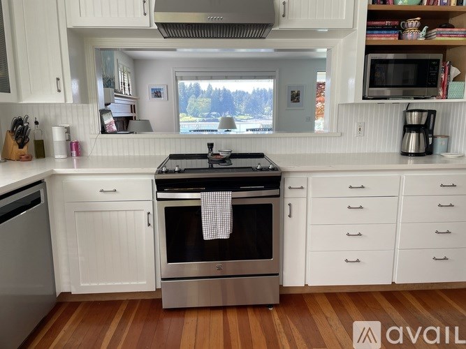 A kitchen with a stove top oven and a window.