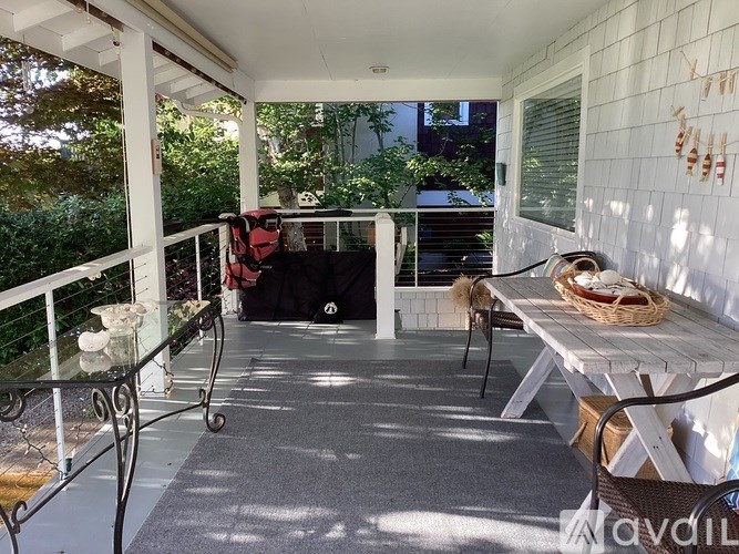 A patio with a table and chairs and a backpack on the floor.