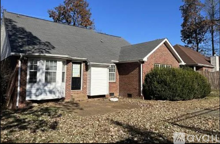 A house with a white garage door and a brick exterior.