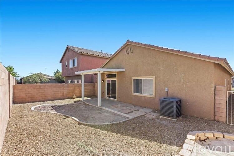 A house with a brown stucco exterior and a covered patio area.