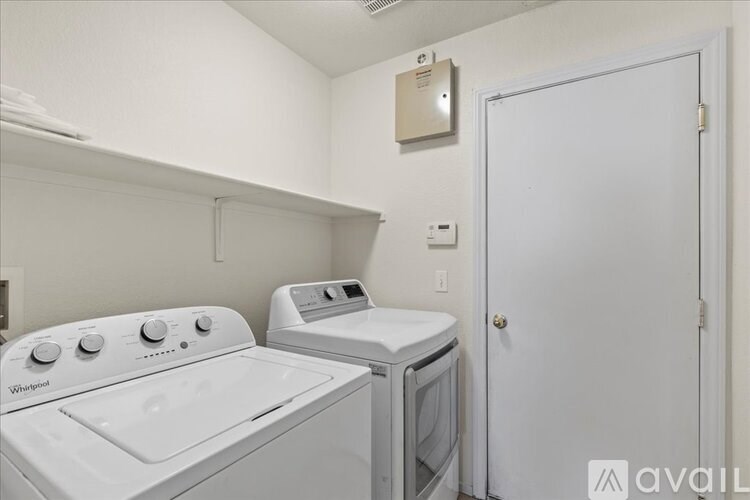 A small laundry room with a washer and dryer.