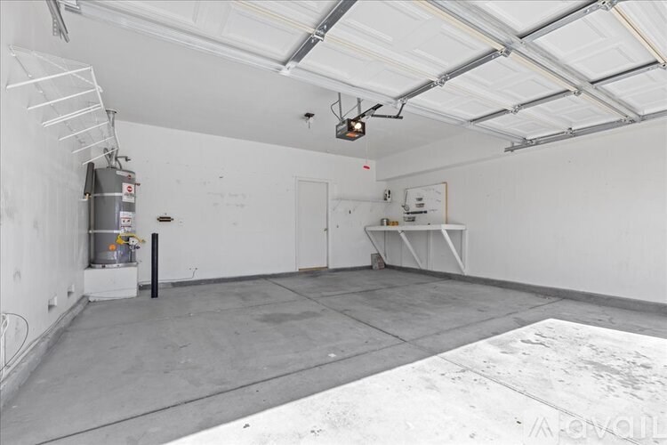 A large, empty room with a white table and a white cabinet.