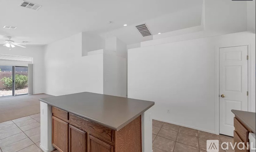 A kitchen with a counter and cabinets is available for rent.