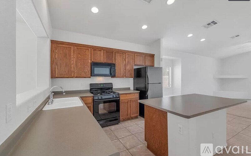 A kitchen with wooden cabinets and black appliances.