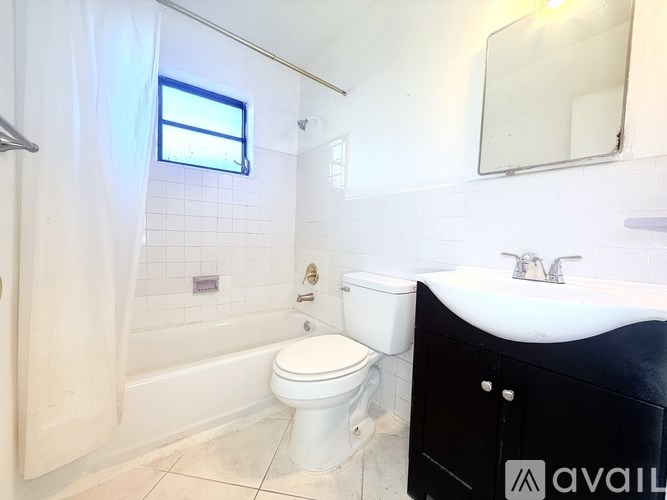 A bathroom with a toilet, sink, and bathtub.