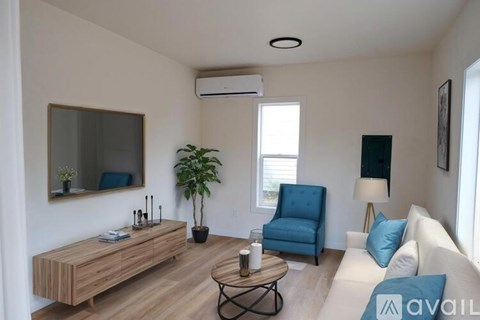 A living room with a blue chair and a wooden bench.