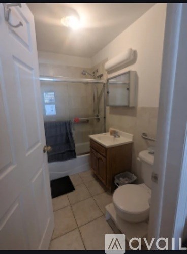 A bathroom with a toilet, sink, and bathtub.