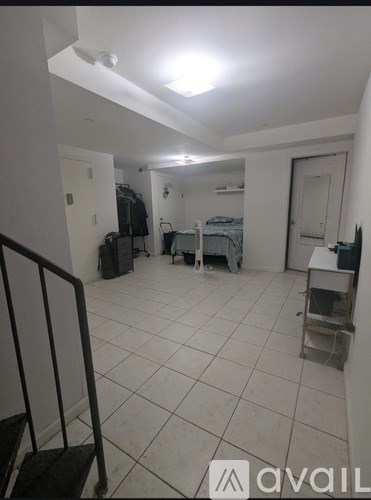 A room with white walls and a white ceiling with a skylight.