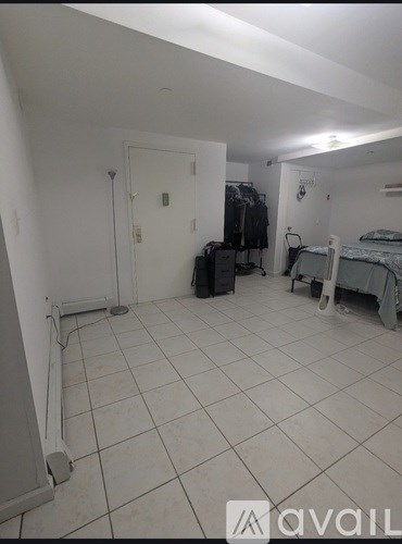 A room with a bed, a wardrobe, and a chair.