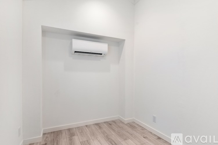 A room with a wall-mounted air conditioner unit.